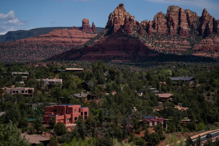 SEDONA, AZ - APRIL 21: A popular tourist destination, Sedona, nestled in the northern Verde Valley region, is perhaps widely known for the red sandstone formations surrounding the city. Here, it acts as a backdrop to homes in the central Arizona city photographed on Tuesday, April 21, 2020 in Sedona, AZ. In early April, in an attempt to slow the spread of the coronavirus pandemic, Arizona Governor Doug Ducey issued an Executive Order emphasizing enhanced physical distance and encouraging Arizonans to stay at home - an order, that is in effect until April 30. (Kent Nishimura / Los Angeles Times)