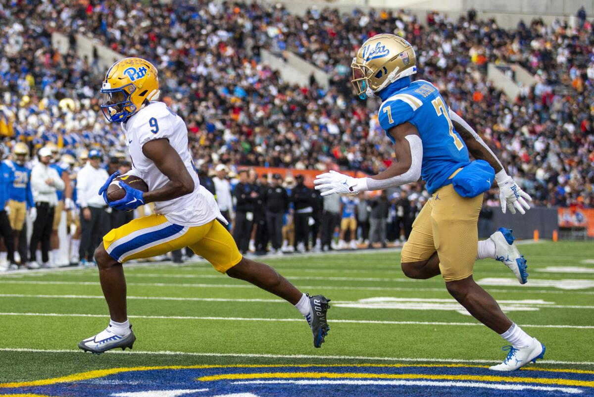 Pittsburgh wide receiver Konata Mumpfield scores a two-point conversion against UCLA defensive back Mo Osling.