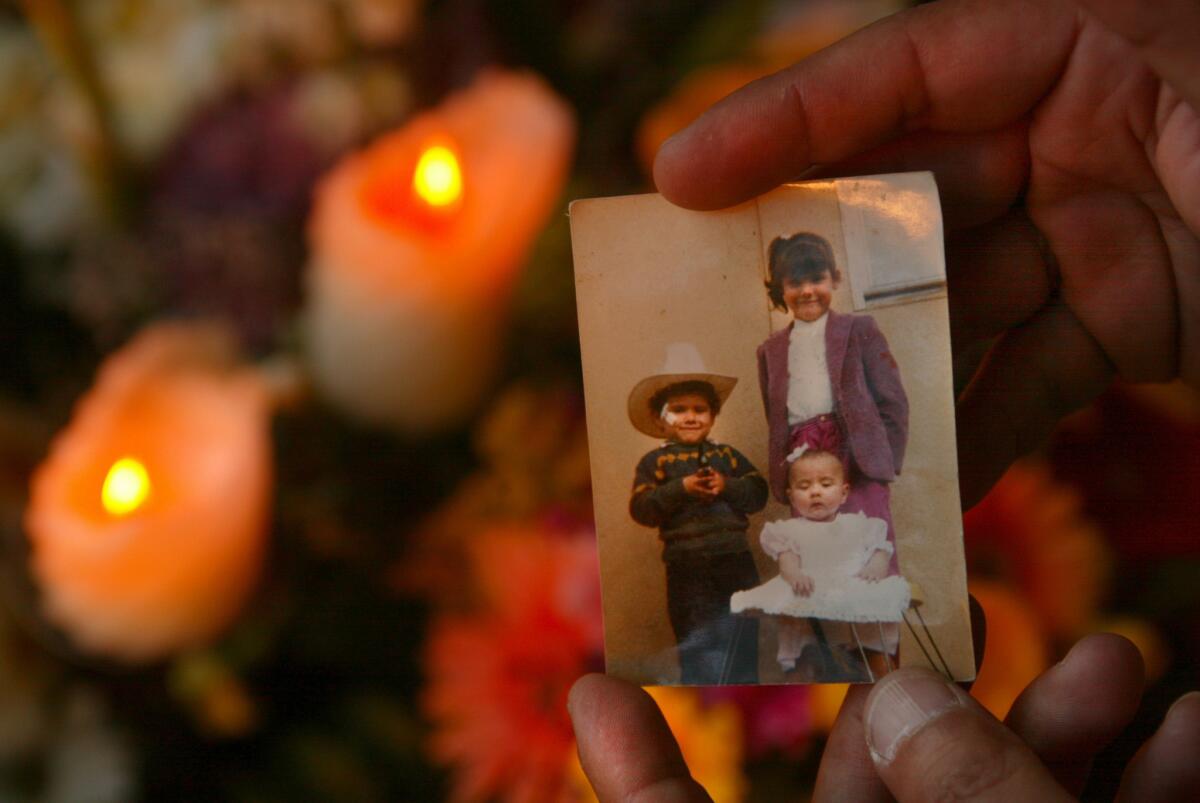 Jesus Suarez del Solar, left, with his sisters in a family snapshot when he was a young boy. (Mark Boster / Los Angeles Times)