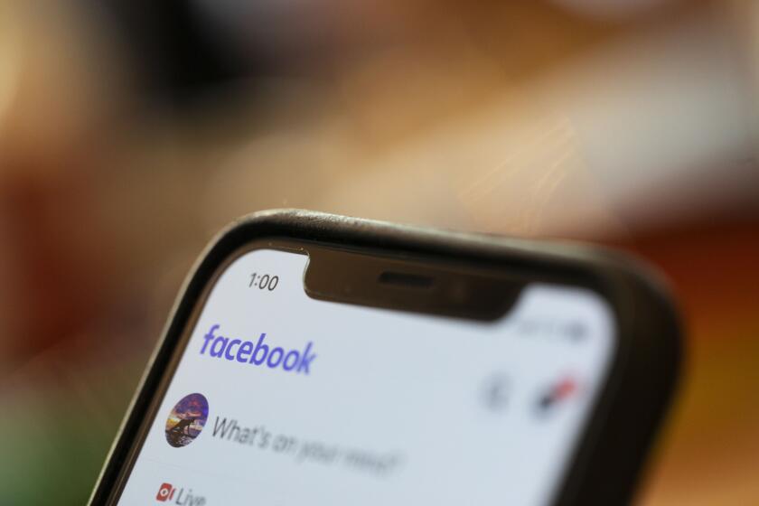 FILE - In this Aug. 11, 2019, file photo an iPhone displays a Facebook page in New Orleans. Facebook says hackers in China used fake accounts and impostor websites in a bid to break into the phones of Uyghur Muslims, Facebook announced Wednesday, March 24, 2021. (AP Photo/Jenny Kane, File)