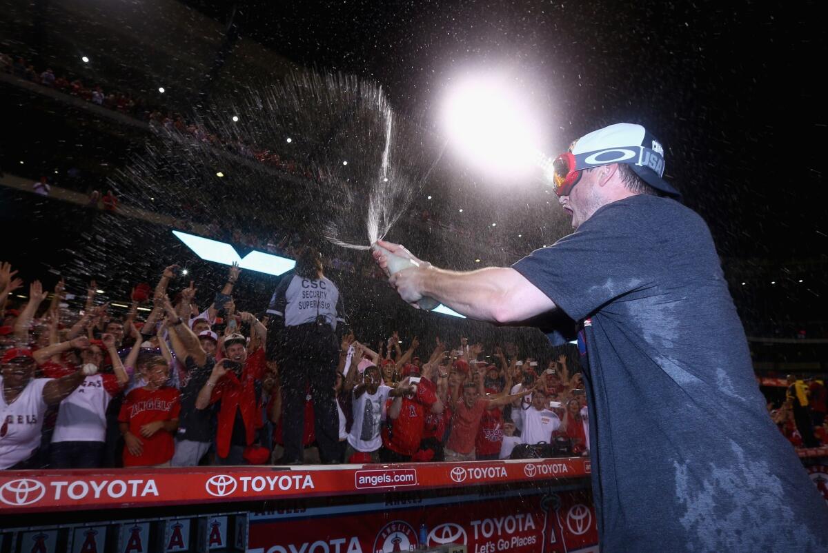 Angels third baseman David Freese celebrates with fans after the team clinched the American League West title on Sept. 17.