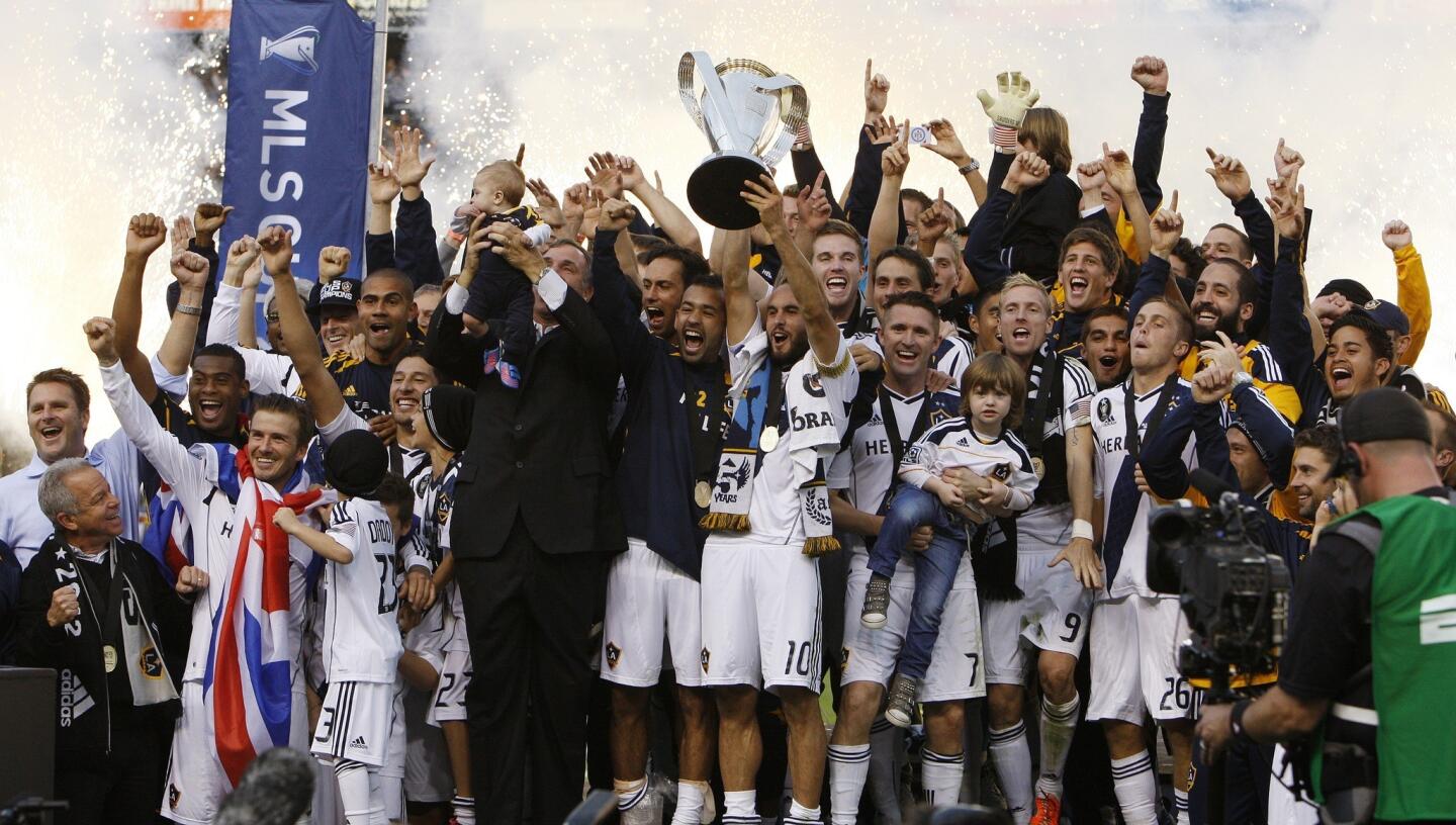 Galaxy players celebrate their 3-1 victory over the Houston Dynamo in the MLS Cup championship game on Saturday at Home Depot Center.