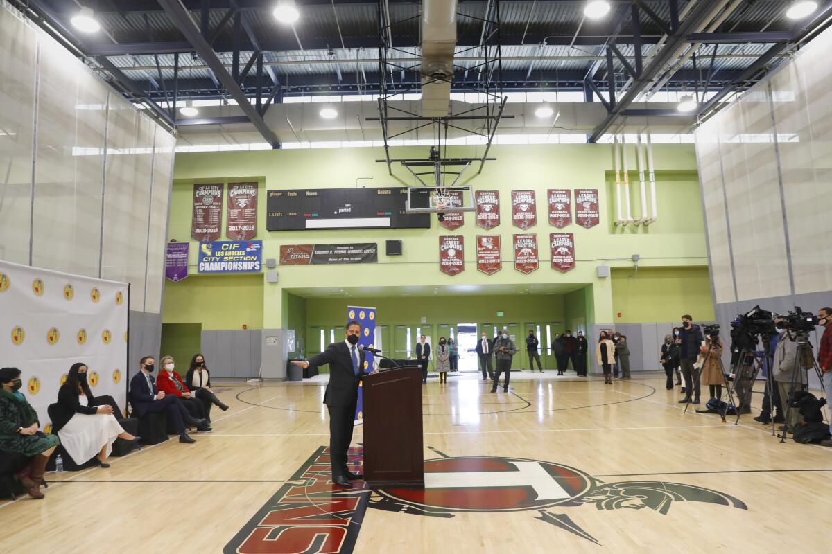 L.A. schools Superintendent Alberto Carvalho speaks to reporters in a school gym