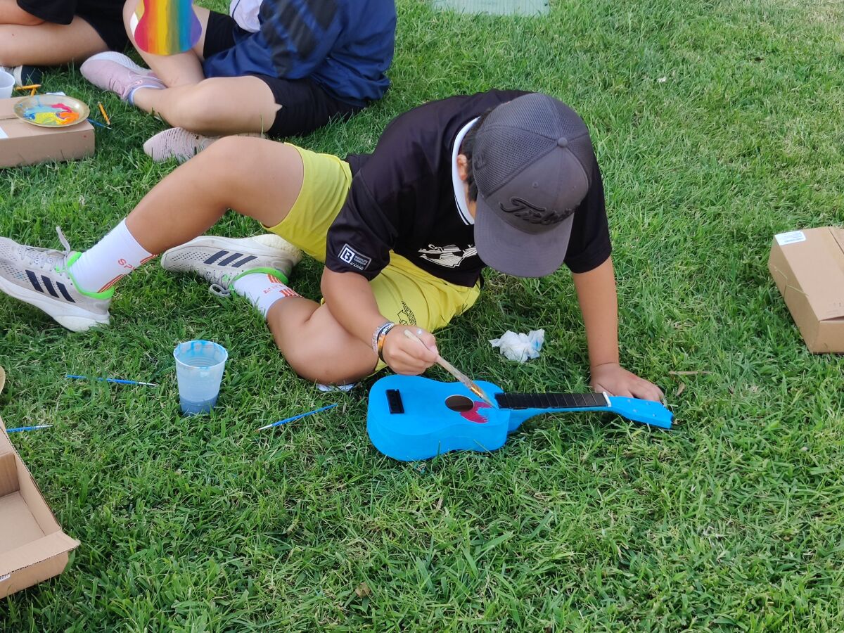A Dwyer Middle School student puts the finishing touches on while painting a ukulele. 