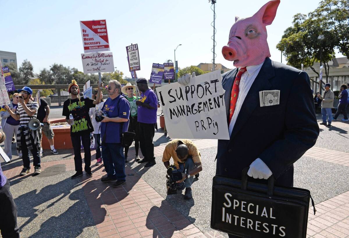 A protester in a pig mask mocks Bay Area Rapid Transit management at a rally with union members at the Lake Merritt BART Station in Oakland. A second strike by transit workers in four months produced traffic jams and frustration Friday, but officials predicted the worst was yet to come.