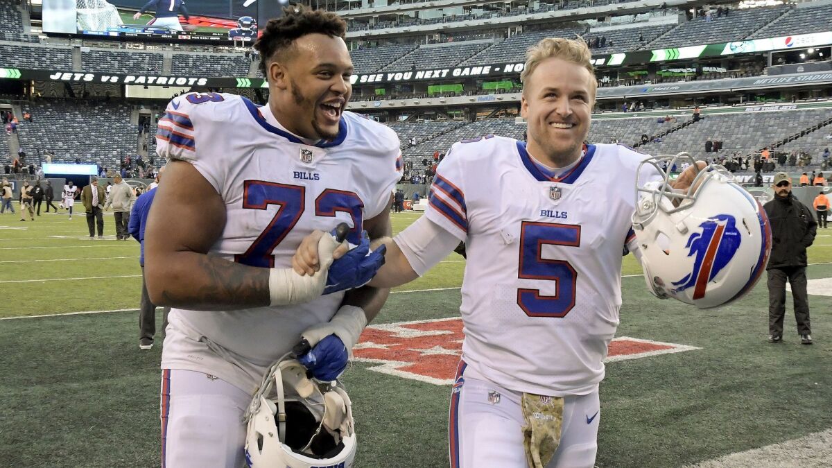 Buffalo Bills quarterback Matt Barkley (5) and Buffalo Bills offensive tackle Dion Dawkins (73) walk off the field after a game against the New York Jets on Nov. 11, 2018, in East Rutherford, N.J.