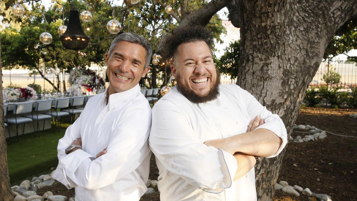 Chefs Tony Esnault, left, and Amar Santana pose for a photo before a special dinner at the Segerstrom home ranch property that heralded two new restaurants coming to South Coast Plaza: Santana’s The Hall Global Eatery and Esnault’s Knife Pleat.