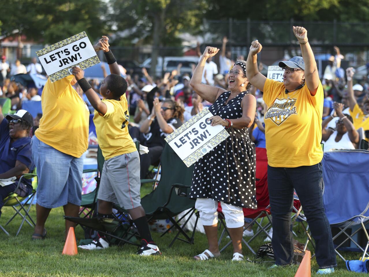 Left to right, front row fans, Felicia Bell, her son Joshua Bell, 10, Saundra Bishop (cq), and Cheryl Patterson, cheer the Jackie Robinson West team during a watch party, at Jackie Robinson Park, at 10540 S. Morgan Park St., in Chicago.
