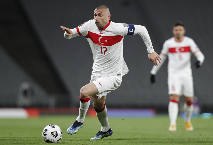 Turkey's Burak Yilmaz runs with the ball during the World Cup 2022 group G qualifying soccer match between Turkey and Netherlands at the Ataturk Olimpiyat Stadium in Istanbul, Turkey, Wednesday, March 24, 2021. (Murad Sezer/Pool Photo via AP)