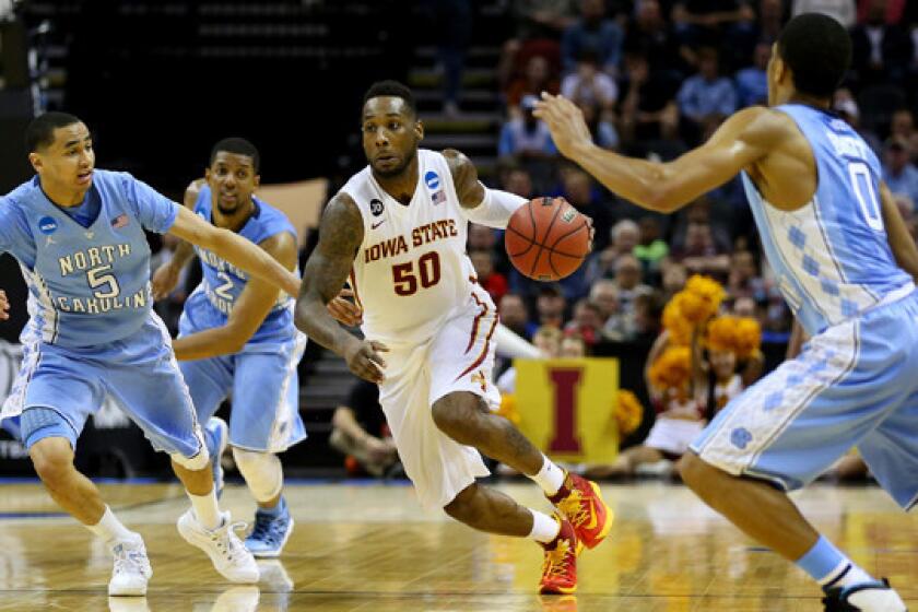 Iowa State's DeAndre Kane drives through the North Carolina defense during the Cyclones' 85-83 victory in the third round of the NCAA tournament Sunday.