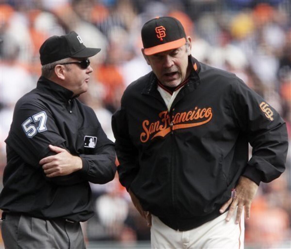 Giants manager Bruce Bochy and closer Brian Wilson celebrate a 3-0