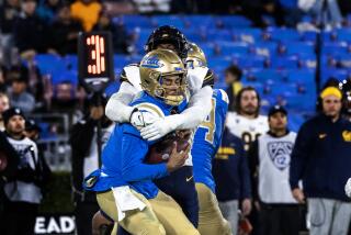 UCLA quarterback Dante Moore is sacked by Cal linebacker David Reese late in the fourth quarter 