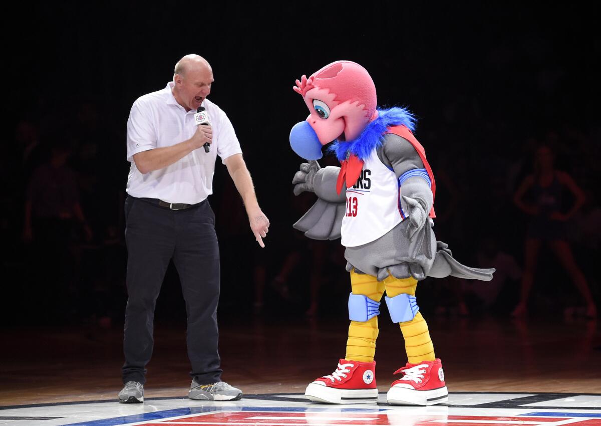 Clippers owner Steve Ballmer introduces the team's new mascot, a California Condor named Chuck, during halftime.