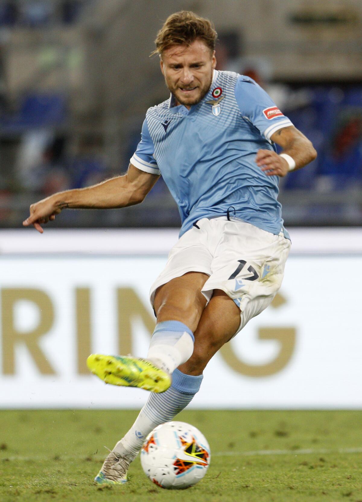 Lazio's Ciro Immobile shoots to score his sides second goal during the Serie A soccer match.