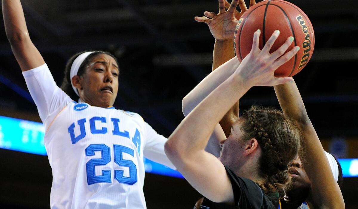 Hawaii's Megan Huff looks to shoot over UCLA's Monique Billings (25) and Kennedy Burke during their NCAA tournament game Saturday.