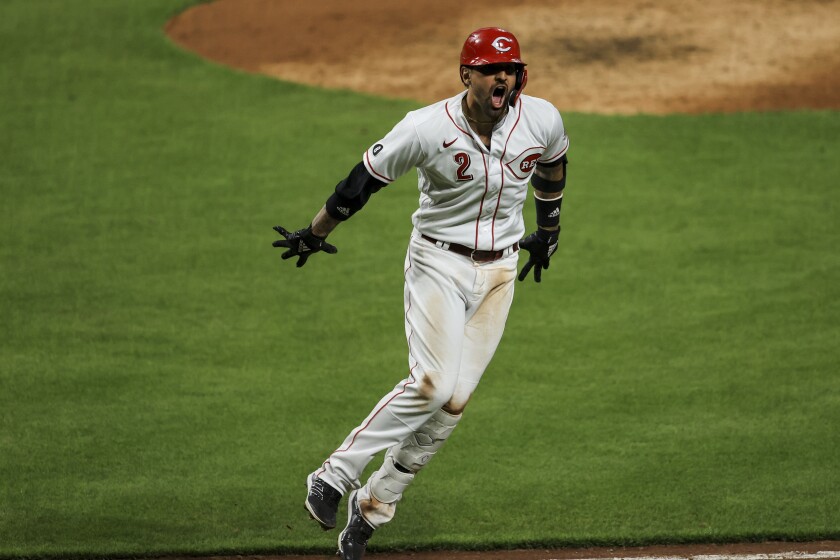 Cincinnati Reds' Nick Castellanos reacts to hitting a solo home run during the seventh inning of a baseball game against the Pittsburgh Pirates in Cincinnati, Monday, April 5, 2021. (AP Photo/Aaron Doster)