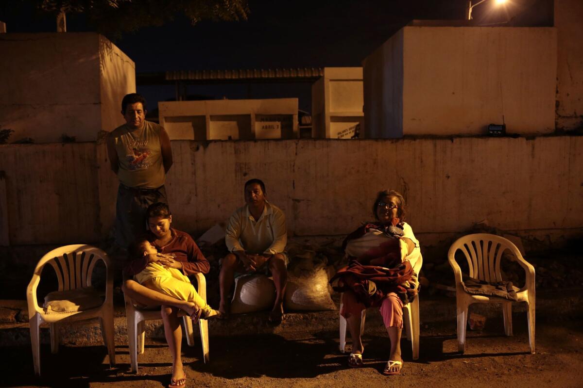 People sit outside their home after a strong earthquake was felt in Manta, Ecuador, on May 18.
