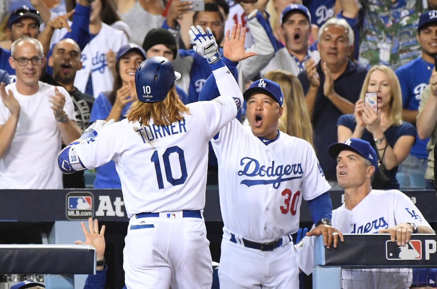 Dodgers third baseman Justin Turner celebrates his three-run home run against the Diamondbacks with manager Dave Roberts in the first inning in Game 1 of the NLDS at Dodger Stadium.