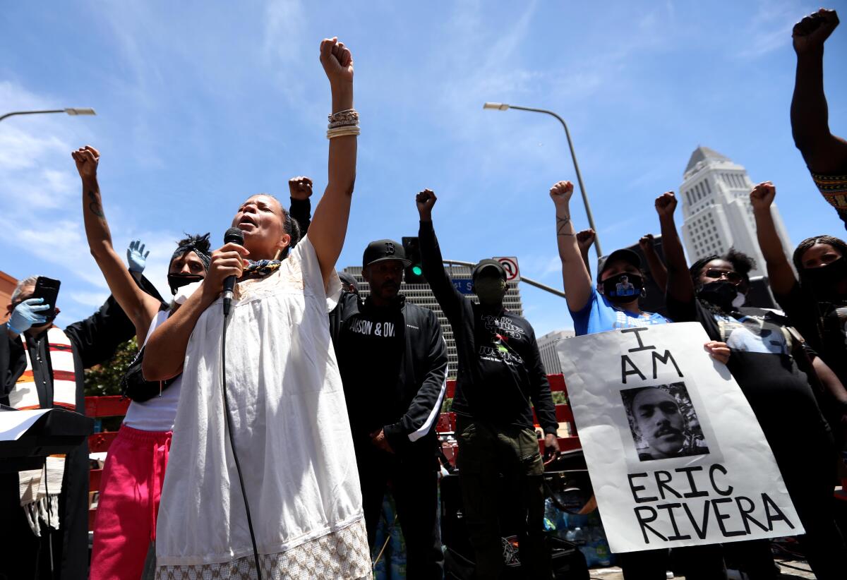 Melina Abdullah, co-founder of Black Lives Matter Los Angeles, raises a fist during a memorial and protest for George Floyd