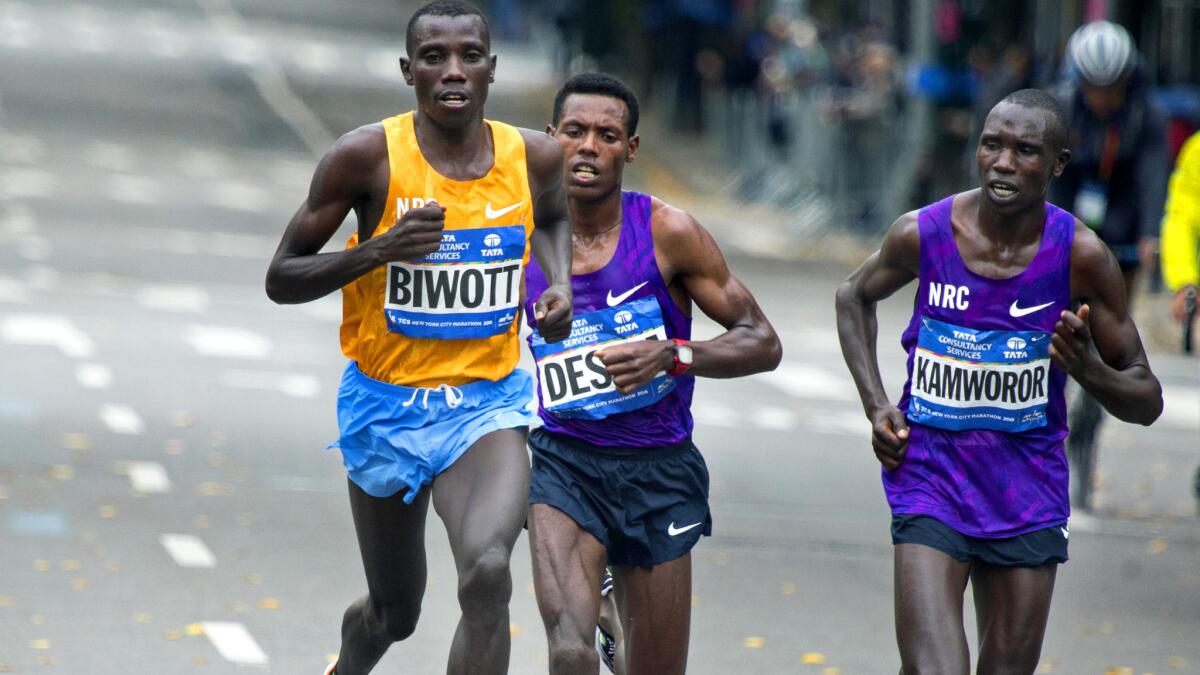 Stanley Biwott begins to pull away from Lelisa Desisa and Geoffery Kamworor at the New York City Marathon on Sunday.