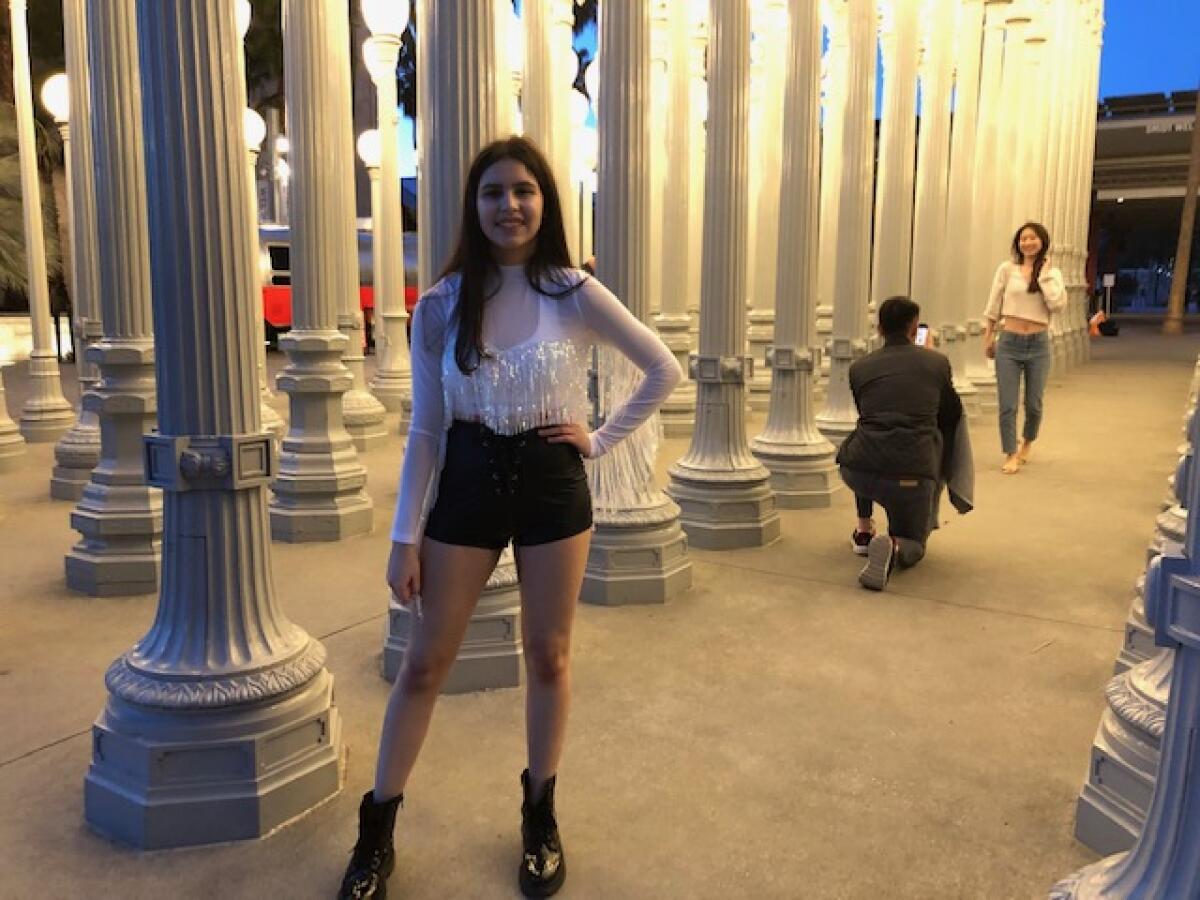 Camila Rios, 15, poses at LACMA's "Urban Light."