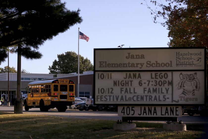 FILE - A school bus arrives at Jana Elementary School on Oct. 17, 2022, in Florissant, Mo. A Missouri school district said Thursday, March 23, 2023, that Jana Elementary School in St. Louis County will remain closed permanently. The school was shut down in October 2022 amid concerns of possible radioactive contamination. It sits near a creek that was contaminated in the 1950s and 1960s with waste from nuclear weapons development. (Christian Gooden/St. Louis Post-Dispatch via AP, File)