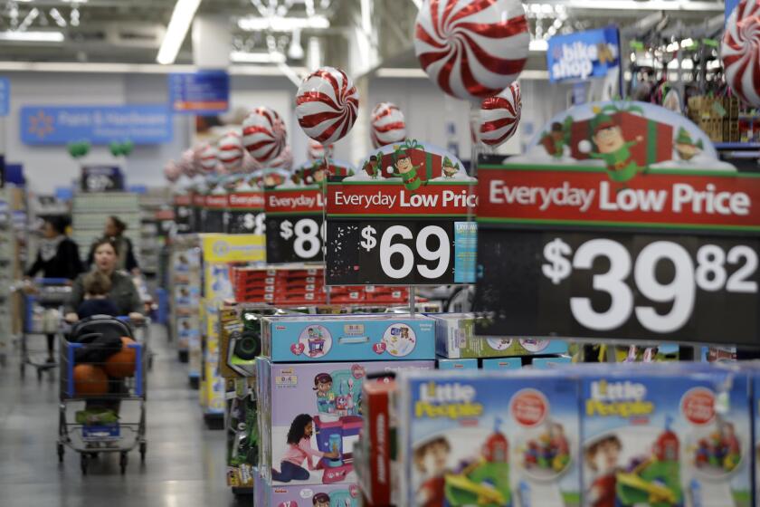 FILE - This Wednesday, Oct. 26, 2016, file photo, shows prices in the toy section at Walmart in Teterboro, N.J. With shoppers moving more seamlessly between stores and mobile devices, retailers are trying to find a balance between investing in both. Until now, Walmart's goal was to keep store and online prices the same. But now itâs raising prices for certain items online that would be unprofitable to ship, and noting that on its website so customers can choose to shop online and pick up from a store. (AP Photo/Julio Cortez, File)