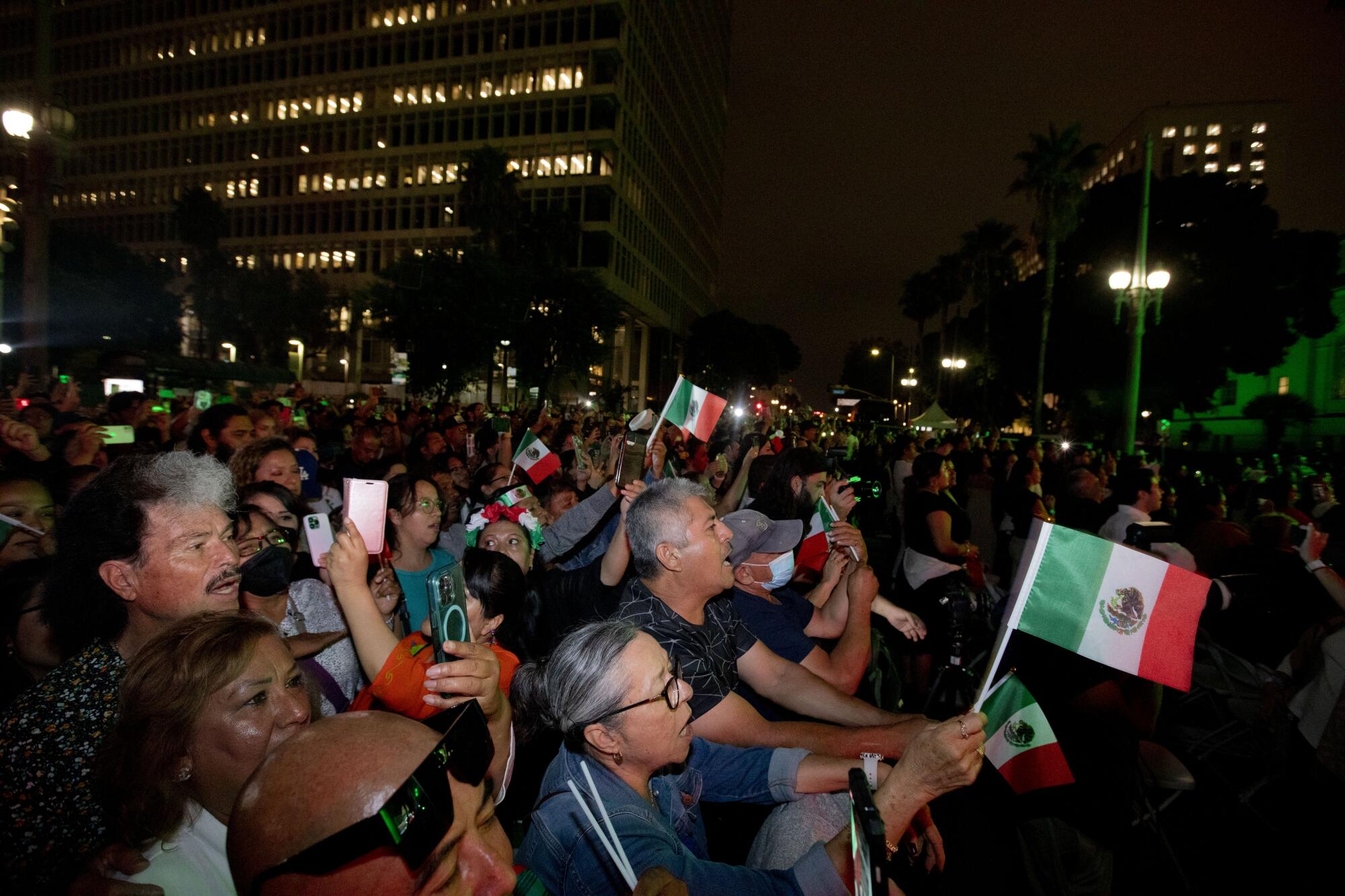 A group of people holding Mexican flags