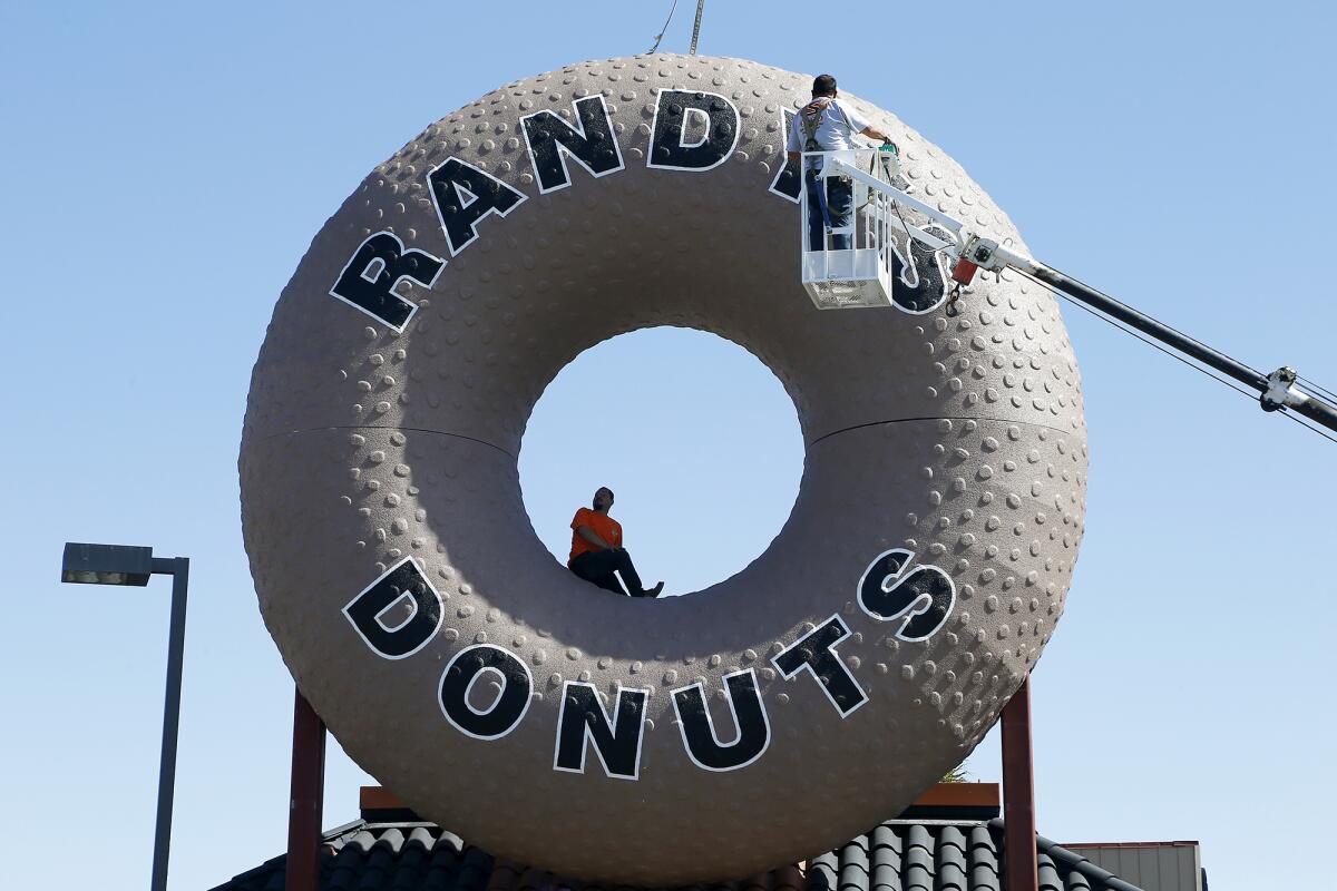 A Randy's Donuts sign is installed along Harbor Boulevard in Costa Mesa on Feb. 25.