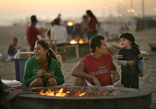 Jessica and Cliff Capps of Long Beach relax with their son Tyler amid friends and a warm fire at Bolsa Chica State Beach. Huntington Beach's almost 600 fire rings likely qualifies it as Southern California's beach fire capital.