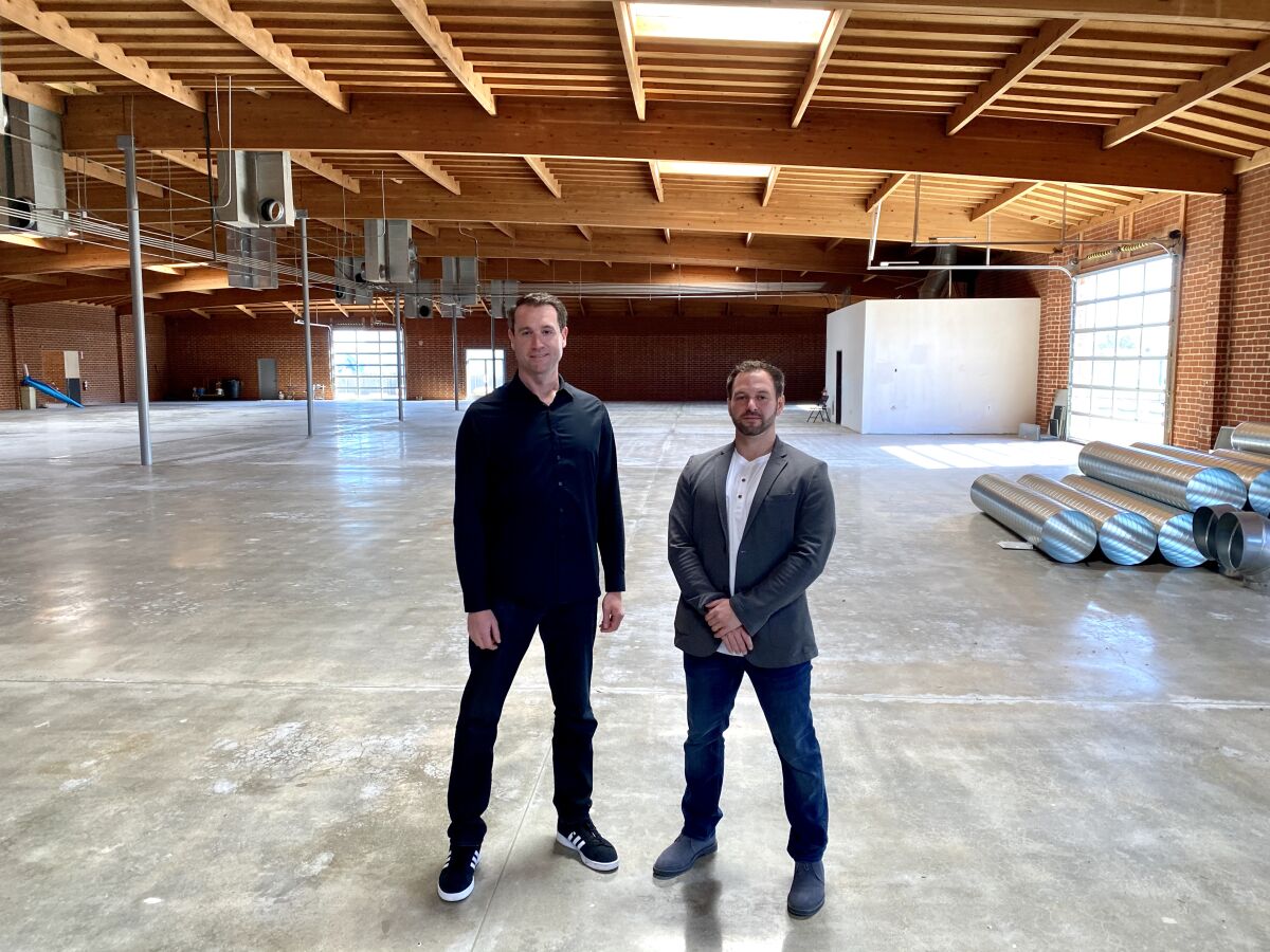 Rob Johnson, COO of Nerd Street Gamers, left, and John Fazio, Founder & CEO of Nerd Street Gamers, stand where Localhost Los Angeles will be built.