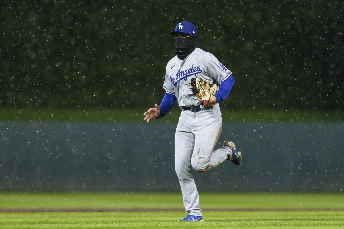 Dodgers second baseman Gavin Lux runs back to the dugout after umpires suspend play because of rain.