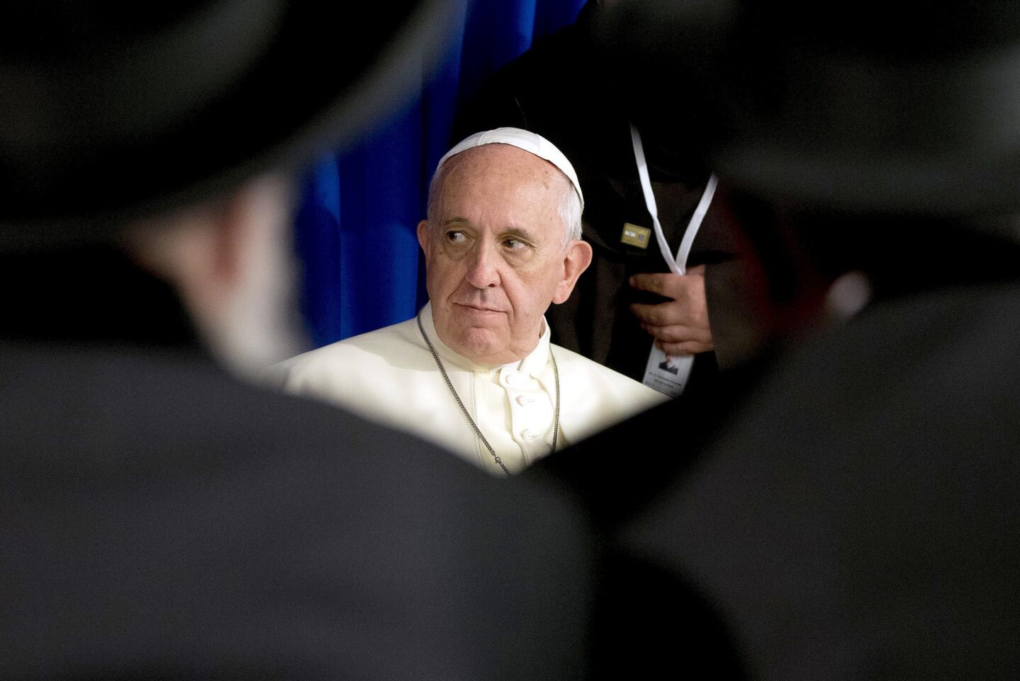 Pope Francis listens to a speech during a visit to the Heichal Shlomo Center in Jerusalem. The pope is facing a diplomatic high-wire act as he visits sacred Muslim and Jewish sites in Jerusalem on the final day of his Middle East tour.