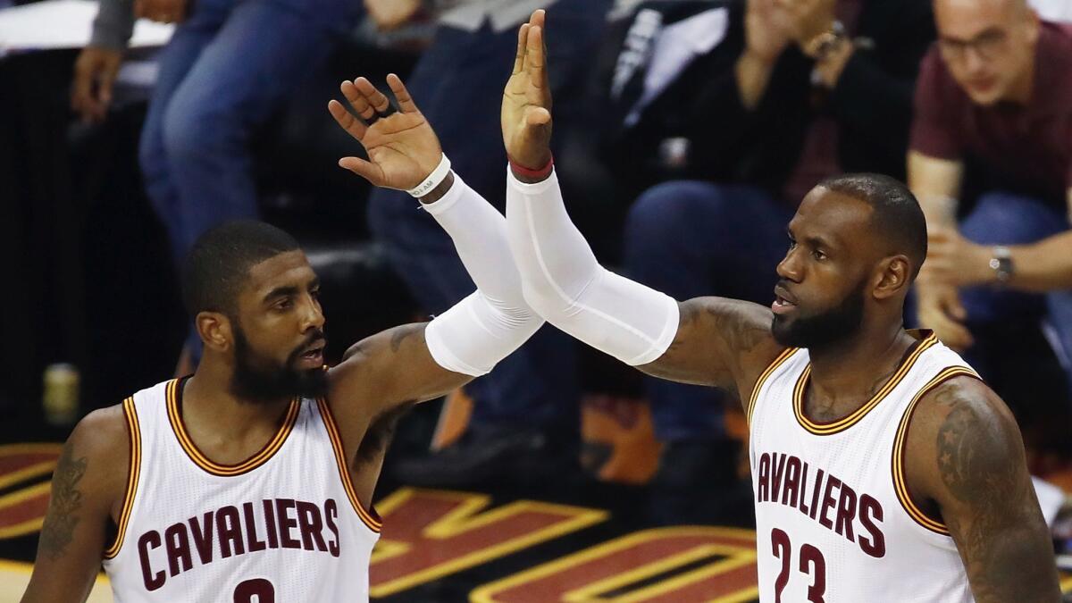 Cleveland's Kyrie Irving, left, and LeBron James celebrate after a play against the Golden State Warriors during Game 4 of the NBA Finals on June 9.