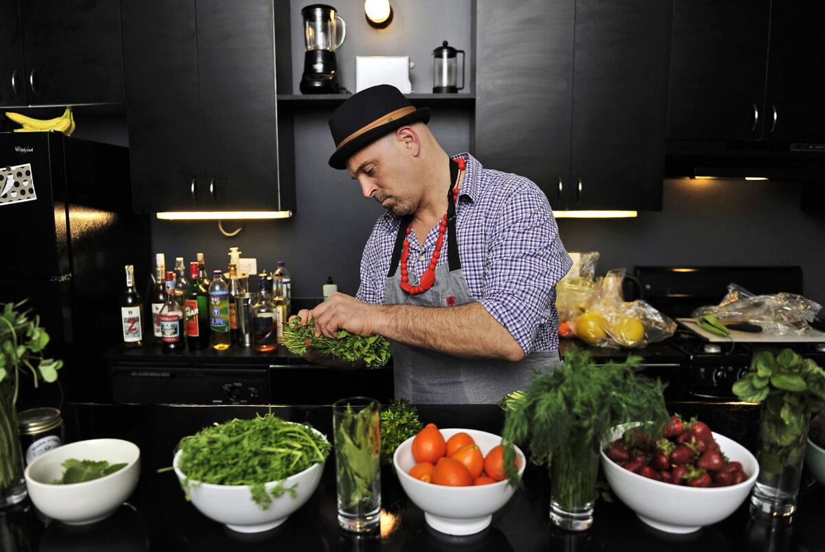 Matthew Biancaniello sets up an array of ingredients he will use to create his unique cocktails at a Feb. 28 event in downtown Los Angeles.