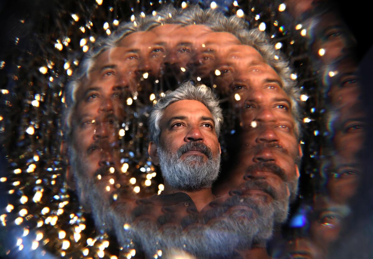 A portrait SS Rajamouli using a filter that multiplies and swirls his face. 