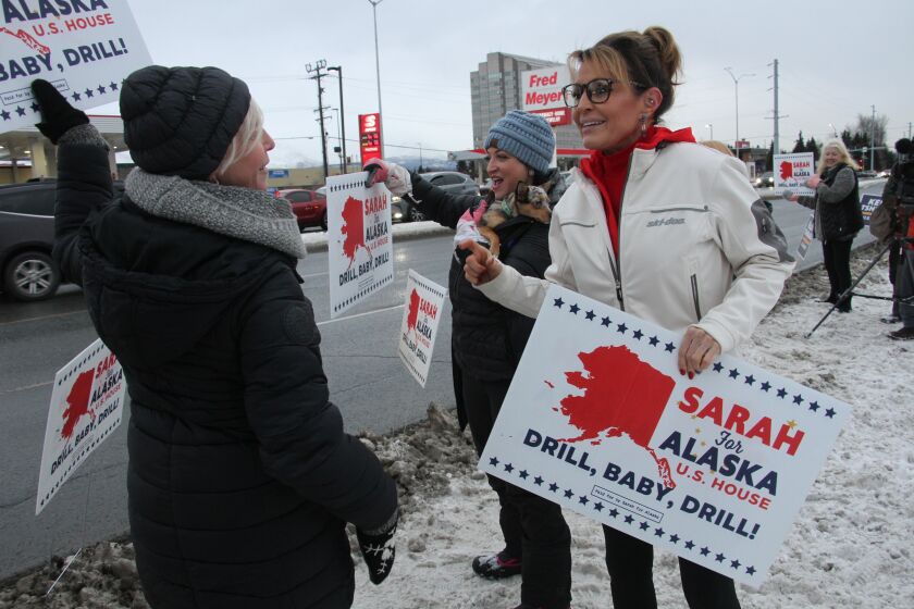 FILE - Former Alaska Gov. Sarah Palin, a Republican candidate for Alaska's sole seat in the U.S. House, meets with supporters waving her signs on Nov. 8, 2022, on a street corner in Anchorage, Alaska. Palin re-emerged in Alaska politics over a decade after resigning as governor with hopes of winning the state's U.S. House seat. But she struggled to catch fire with voters and ran what critics saw as a lackluster campaign against a breakout Democrat who pitched herself as a regular Alaskan and a Republican backed by state GOP leaders. (AP Photo/Mark Thiessen, File)