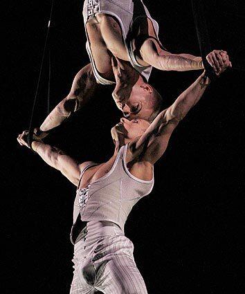 Cirque du Soleil performers sail through the air above the audience during a special sneak preview of the company's new production "Iris."