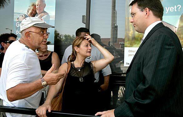 A customer argues with Robert Brown, right, from the Federal Deposit Insurance Corp., while Hanita Horowitz, center, explains how she had waited in line more than 10 hours the day before. They are in front of Indymac Bank in Encino.