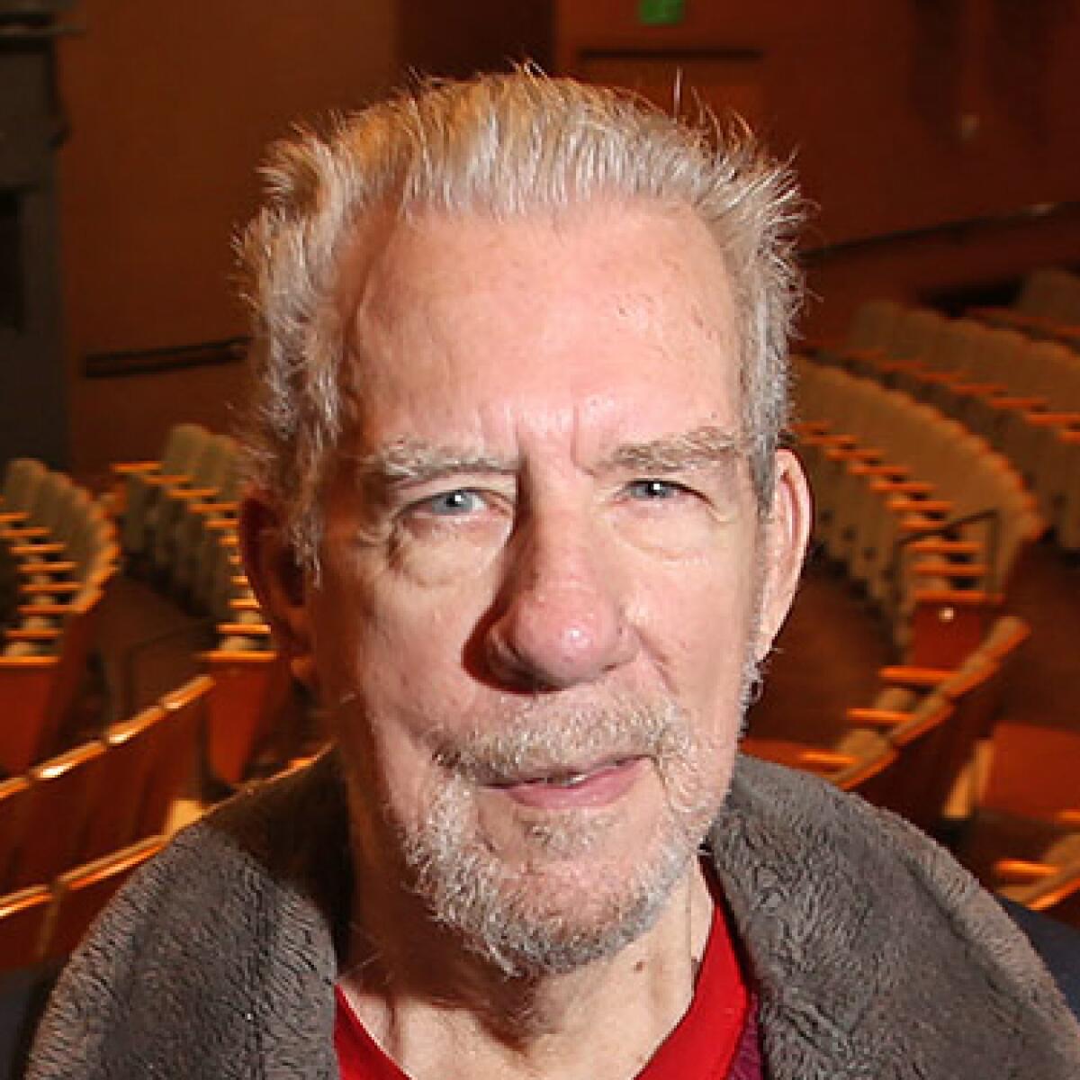 Tom Titus stands in the Segerstrom stage at South Coast Repertory, in 2021.
