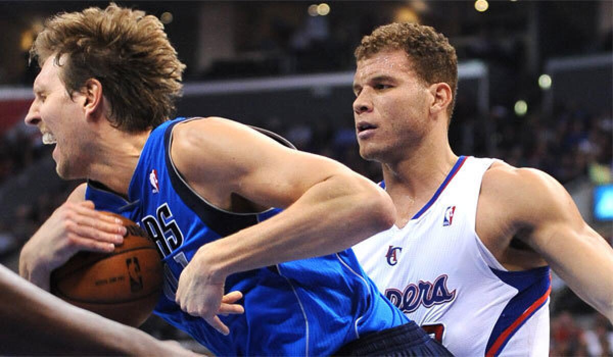 Dallas' Dirk Nowitzki grabs a loose ball from the Clippers' Blake Griffin at Staples Center last January.