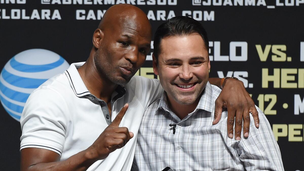 Bernard Hopkins, left, and Golden Boy Promotions President Oscar De La Hoya pose at a weigh-in for Saul "Canelo" Alvarez and Erislandy Lara in Las Vegas on July 11.