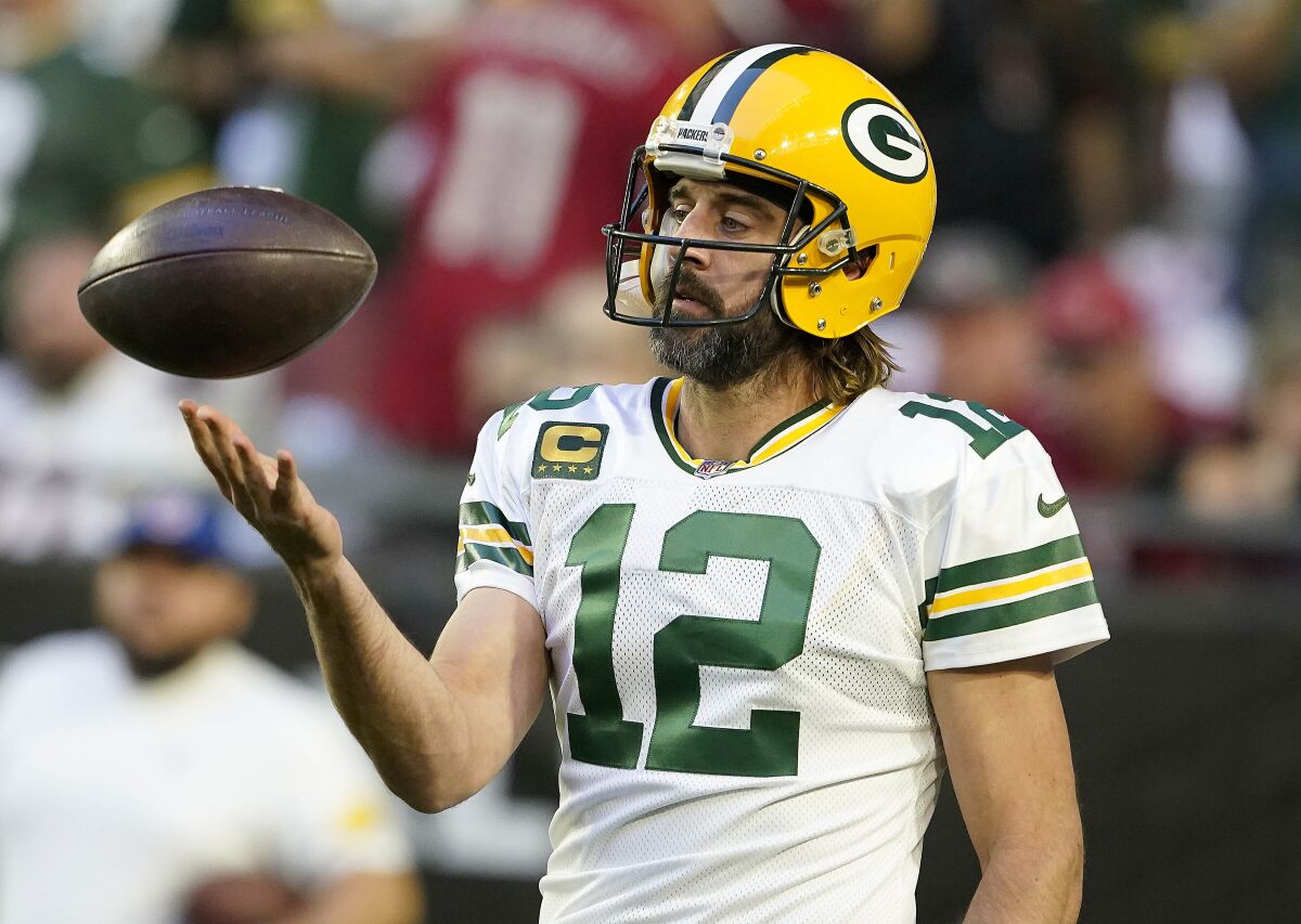 Aaron Rodgers tossing a football