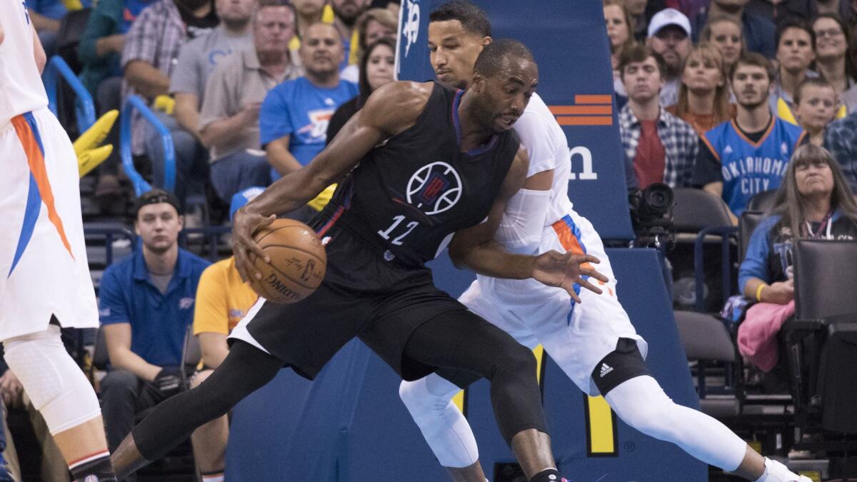 Clippers' Luc Mbah a Moute tries to work around Oklahoma City's Andre Roberson on Nov. 11.