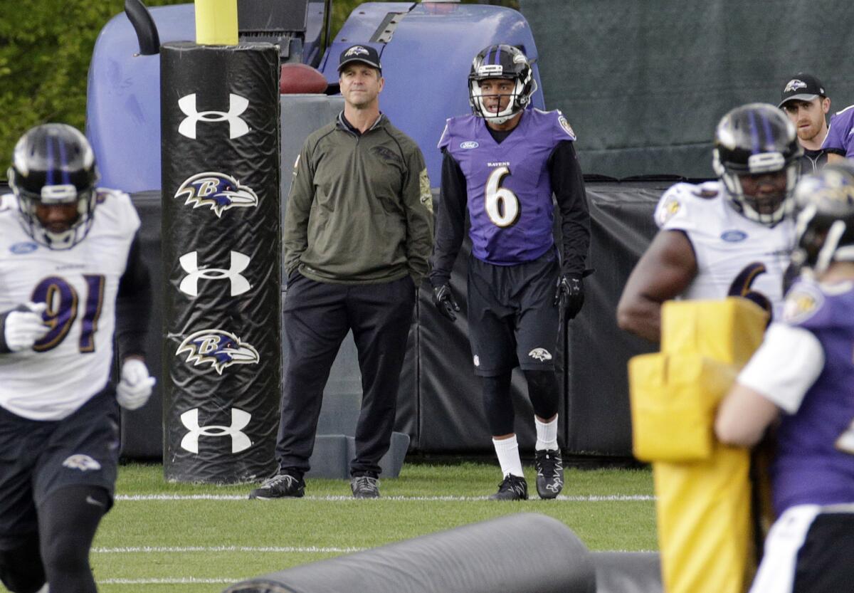 Baltimore Coach John Harbaugh and wide receiver Keenan Reynolds watch a drill during rookie minicamp May 7.