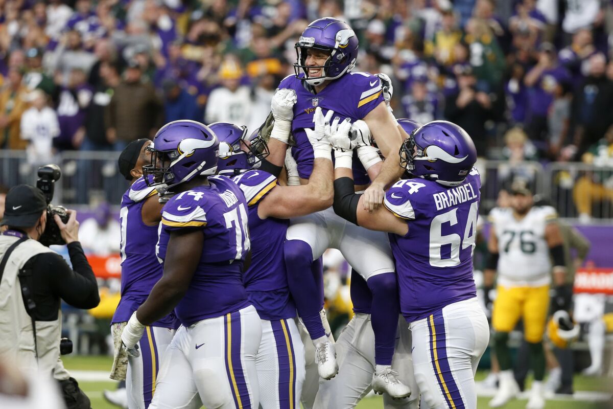 FILE - Minnesota Vikings kicker Greg Joseph, center, celebrates with teammates after kicking a 29-yard field goal on the final play of an NFL football game against the Green Bay Packers, Sunday, Nov. 21, 2021, in Minneapolis. The Vikings won 34-31. In a deal announced Monday, March 14, 2022, the Vikings tendered a contract offer to restricted free agent kicker Joseph. (AP Photo/Bruce Kluckhohn, File)