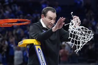 Duke coach Mike Krzyzewski celebrates while cutting down the net after a win over Arkansas on March 26, 2022.