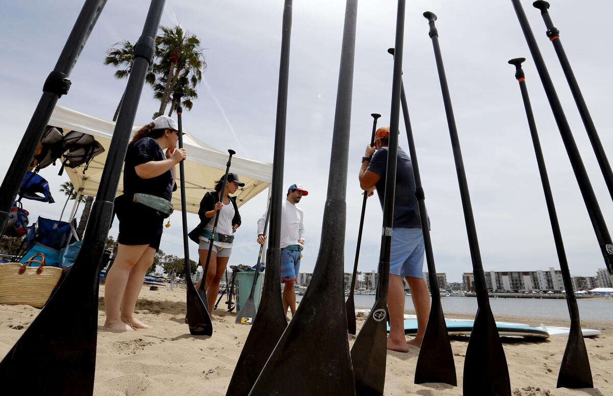 Students take beginners lessons from Tim Sanford, right, of Paddle Method: Stand Up Paddle Board LA in Marina del Rey.