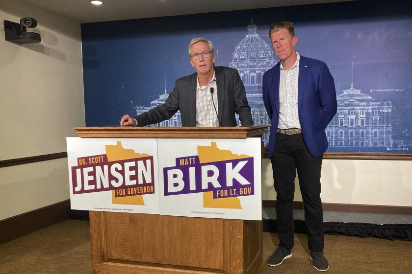 GOP gubernatorial candidate Scott Jensen, left, and his running mate, Matt Birk, speak at a news conference at the State Capitol in St. Paul, Minn., Monday, Sept. 26, 2022. Jensen and Birk attacked Democratic Gov. Tim Walz over how his administration handled the investigation into the nonprofit Feeding Our Future, which is now the target of a $250 million federal fraud case. (AP Photo/Steve Karnowski)