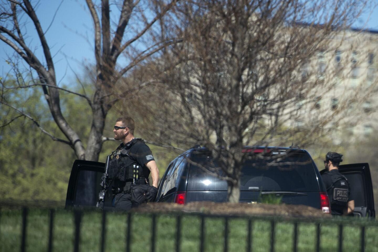 Secret Service agents patrol the North Lawn during a brief precautionary lockdown of the White House in Washington, DC, on March 28, 2016.